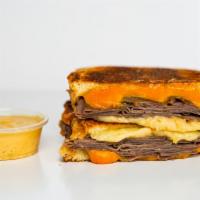 Roast Beef And Three Cheese Melt · Roast Beef, Gruyère, White Cheddar and American cheeses melted between buttery, toasted sour...