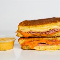 Smoked Ham And Three Cheese Melt · Smoked ham, Gruyère, White Cheddar and American cheeses melted between buttery, toasted sour...