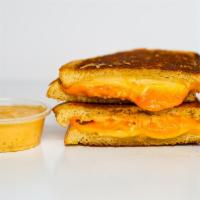 Three Cheese Grilled Cheese · Gruyère, White Cheddar and American cheeses melted between buttery, toasted sourdough bread....