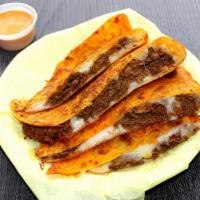 Quesadilla · Cooked tortilla that is filled with cheese and folded in half.