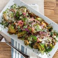 Brussel Sprouts · Pan-seared whole grain mustard, balsamic vinegar, bacon, goat cheese, pickled onion.