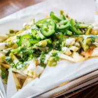 Shah Fries · Hand cut fries topped with fresh jalapeños, cilantro, drizzled garlic yogurt and green chutn...