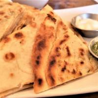 Bolani · House-made flatbread lightly pan fried filled with a potato mash of onion, garlic and cayenn...