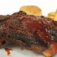 Bbq Style Ribs (Baby Back) · 12 oz. BBQ pork ribs (six to eight pieces), potato wedges, roll and salad.