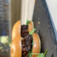 Kobe Beer Sliders · Kobe beef sliders on a sweet roll with Chipotle, arugula and caramelized onions