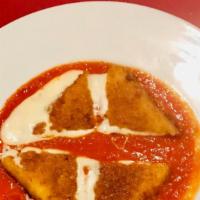 Mozzarella In Carroza · Breaded, deep-fried mozzarella over tomato sauce.