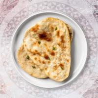 Plain Naan · A traditional Indian flatbread made with refined flour and baked in a tandoor oven.