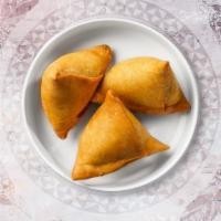 Samosa · Vegetable masala stuffed in a flaky pastry shell and deep fried.