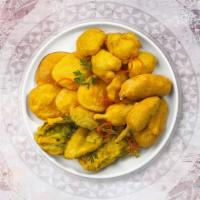 Mixed Vegetable Pakora · Shredded farm fresh spring vegetables mixed with basin flour and deep fried. Served with spi...