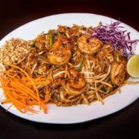 Pad Thai · Stir fried noodles with bean sprouts, onions, eggs, and tamarind sauce, topped with peanuts.