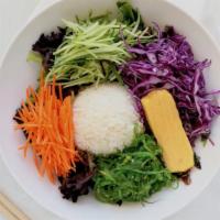 Bi Bim Bap · A rice bowl with julienned carrots, cucumbers, red cabbage, seaweed salad on top of lettuce ...