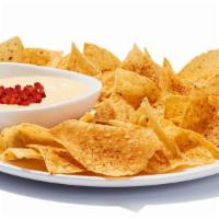 Chips & Queso · Creamy blend of melted cheeses mixed with roasted red and green peppers, topped with housema...