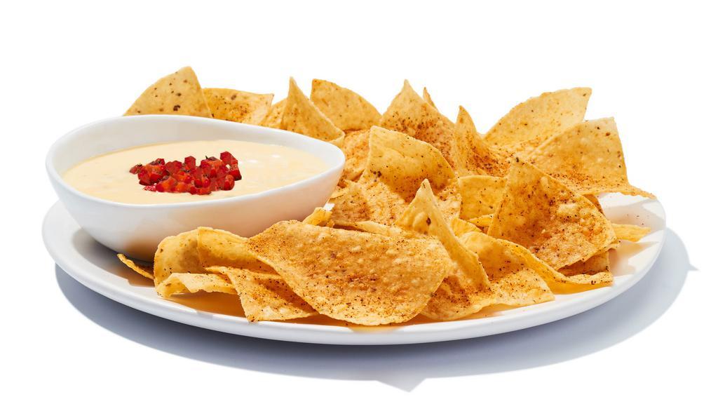 Chips & Queso · Creamy blend of melted cheeses mixed with roasted red and green peppers, topped with housemade pico de gallo, and served with corn chips.  840 cal