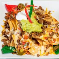 Super Nachos · Tortillas chips covered with melted cheese, beans, sour cream, guacamole, jalapeños, pico de...