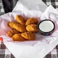 Jalapeño Poppers · Juicy jalapeño poppers filled with cheese, breaded and deep-fried to golden perfection.