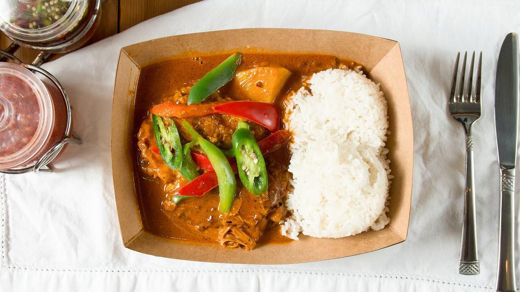 Massaman Chicken Curry · Massaman curry paste made from scratch, coconut milk, bone-in chicken, red and green bell peppers, peanuts, topped with serrano peppers.