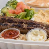 Kefta (Lule) Kebab · Two skewers flame-broiled seasoned lean ground beef served with rice, hummus, Greek salad an...