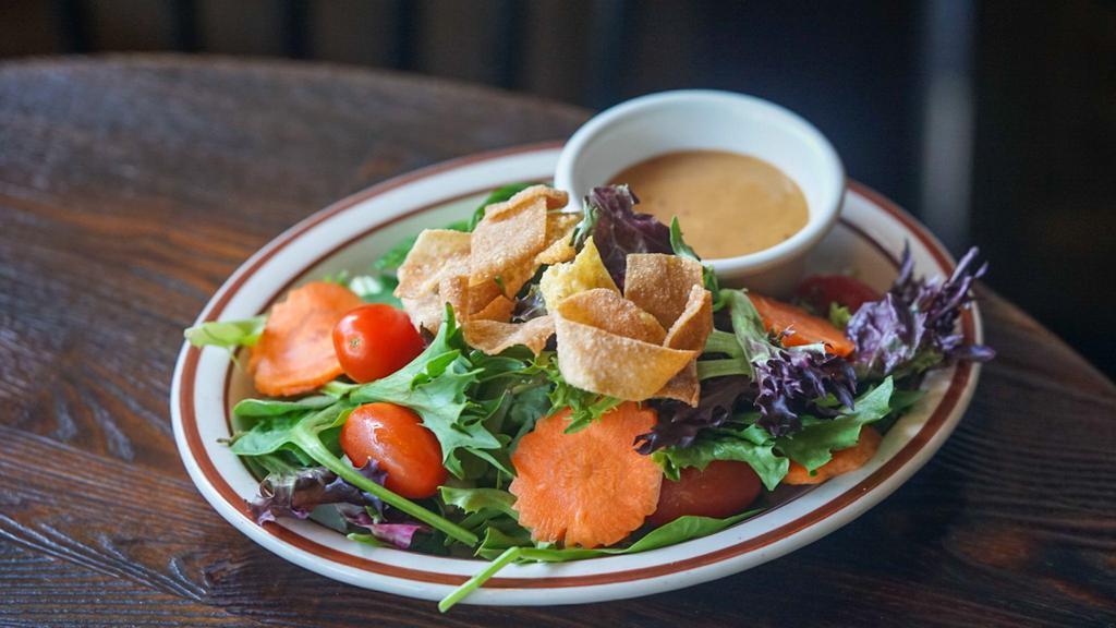 House Salad · Mixed greens, romaine hearts, cucumbers, grape tomatoes, carrots and crispy noodle croutons - peanut dressing.