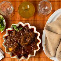 Yebeg Siga Wot · Mild lamb stew, delicately spiced with garlic, ginger, and other spices. Served with injera ...