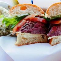 Roast Beef Sandwich · Medium rare roast beef served with Swiss cheese, mayo, onion, lettuce and tomato on our Fren...