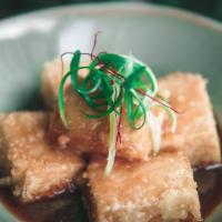 Yuzu Miso Agedashi Tofu · Vegan. Tofu with miso sauce, topped with chili thread and green onions.