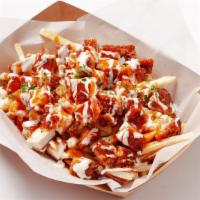 Buffalo Chicken Fries · Shoestring french fries topped with fried chicken breast, house made buffalo sauce, ranch dr...
