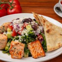 Mediterranean Salmon Salad · Grilled Atlantic Salmon on a Bed of Mixed Greens. Topped with Cucumber, Roma Tomatoes, Red O...