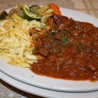 Traditional Hungarian Goulash · Slow cooked beef stew, Hungarian paprika, served with German spaetzle.
