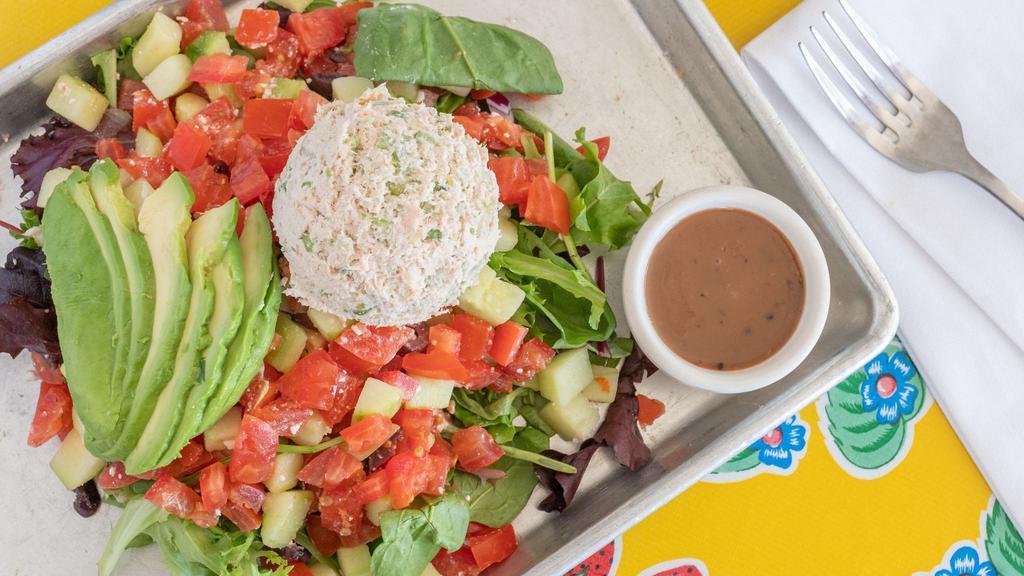 Albacore Tuna Salad · Mixed greens topped with a scoop white albacore tuna, avocados, sliced cucumbers and tomatoes, house vinaigrette on the side.