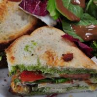 Chicken Pesto Sandwich · Tomato greens, mozzarella, toasted sourdough served with side salad.