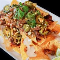 Super Nachos · w/ Choice of Meat, Beans, Guacamole, Sour Cream, Cheese