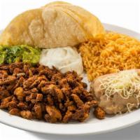 Al Pastor Dinner Plate · Al Pastor, with a side of beans, rice, guacamole, sour cream & served with three handmade to...