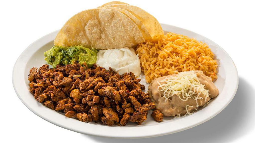 Al Pastor Dinner Plate · Al Pastor, with a side of beans, rice, guacamole, sour cream & served with three handmade tortillas.