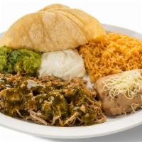 Chile Verde Dinner Plate · Chile Verde with a side of beans, rice, guacamole, sour cream & served with three handmade t...