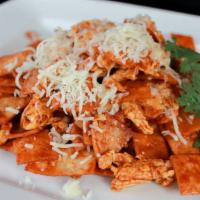 Chilaquiles Rojos O Verdes · Lightly fried tortilla chips cooked with eggs, red or green hot sauce & topped sour cream, c...