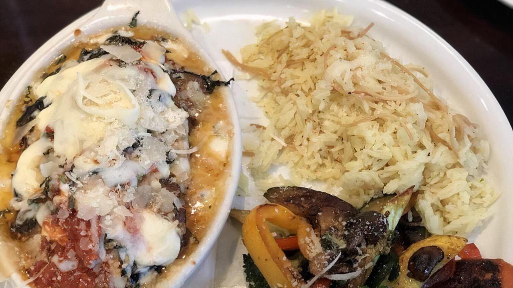 Parmigiana · Chicken or eggplant. Parmigiana romano floured, sauteed, and baked. Served with rice pilaf and grilled seasoned veggies.