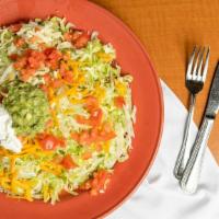 Tostada Compuesta · Pork, chicken or beef with beans, lettuce, tomatoes, cheese, sour cream and guacamole on a c...