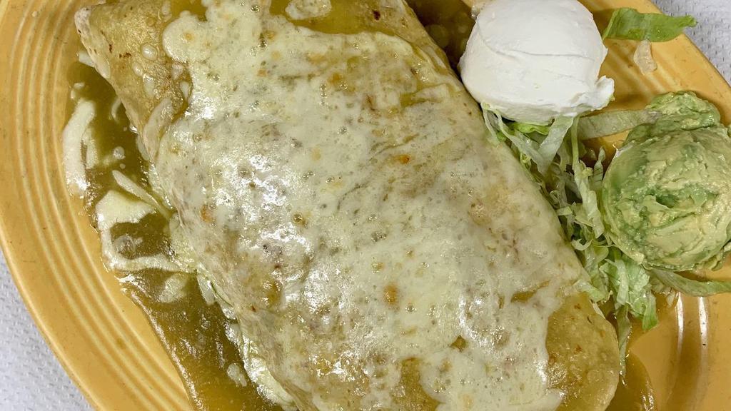 Oven Burrito Deluxe · Pork, chicken or shredded beef with beans, topped with verde, red or ranchera sauce and melted cheese with sour cream and guacamole.