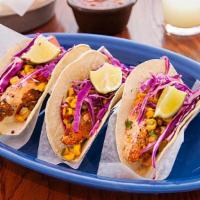 3 Original Fish Tacos · Tortilla encrusted fish, roasted corn salsa, shredded red cabbage and chipotle aioli on whit...