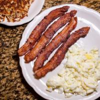 Canadian Bacon & Eggs · Three generous Canadian bacon pieces are hand-sliced.