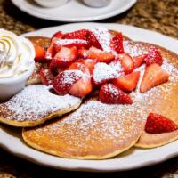 Fresh Strawberry Pancakes · Buttermilk pancakes topped with fresh sweet strawberries and real whipped cream.