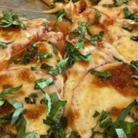 Margherita Pizza · Thin sliced tomato,fresh mozzarella, basil and garlic.