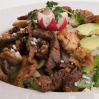 Chicken Fajita Salad · Marinated grilled chicken served over black beans, melted cheese, sautéed vegetables, romain...