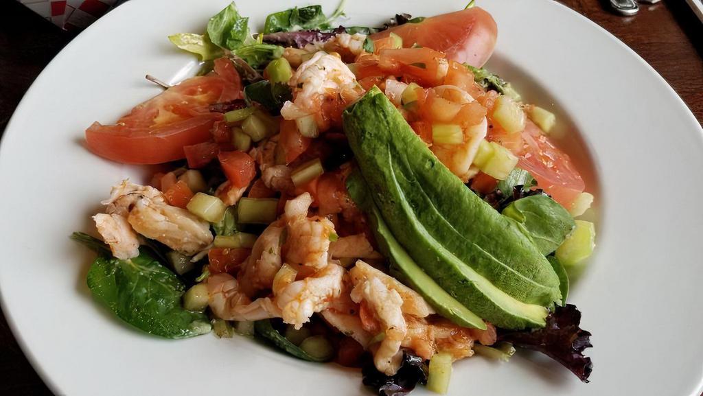 Ceviche Salad · Mixed green salad with cilantro lime dressing topped with shrimp and fish cooked in lime juice, mixed with onions, cucumbers, avocado, tomato, jalapeño and cilantro.