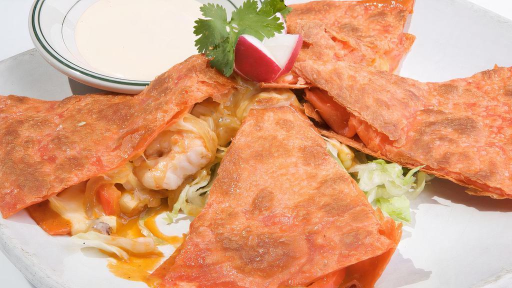 Quesadilla De Camaron · Sautéed shrimp, grilled corn, red bell peppers and onions on a tomato flour tortilla with melted cheese garnished with iceberg lettuce and chipotle cream dip.
