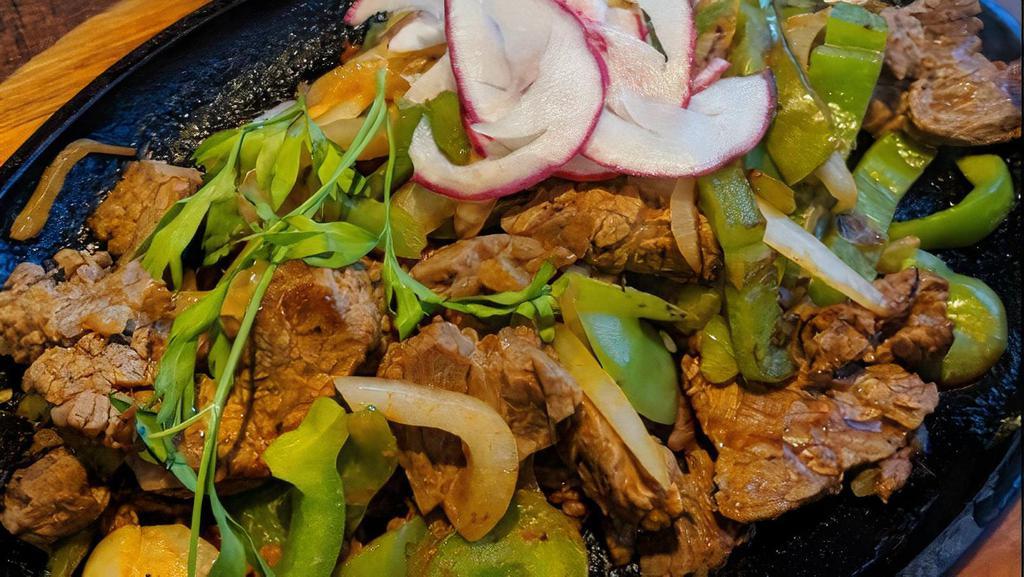 Fajitas De Pollo (Chicken Fajitas) · Mexquite favorites. Marinated chicken breast sautéed with green bell peppers and onions served with Mexican rice, refried beans, guacamole, sour cream and pico de gallo.