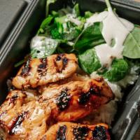 Teriyaki Salmon Don · Grilled Salmon glazed with teriyaki sauce, served over steamed white rice and side salad top...