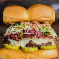 The Mensch Burger · White American cheese, pickles, pastrami, haus slaw, and 1001 island on a King's Hawaiian ro...