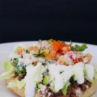 Sopes · Choice of meat, beans, pico de gallo, lettuce, Cotija cheese.