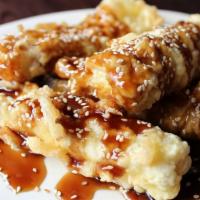 Sesame Tofu Appetizer · Tempura battered fried Tofu drizzled with Teriyaki Sauce and topped with Sesame Seeds